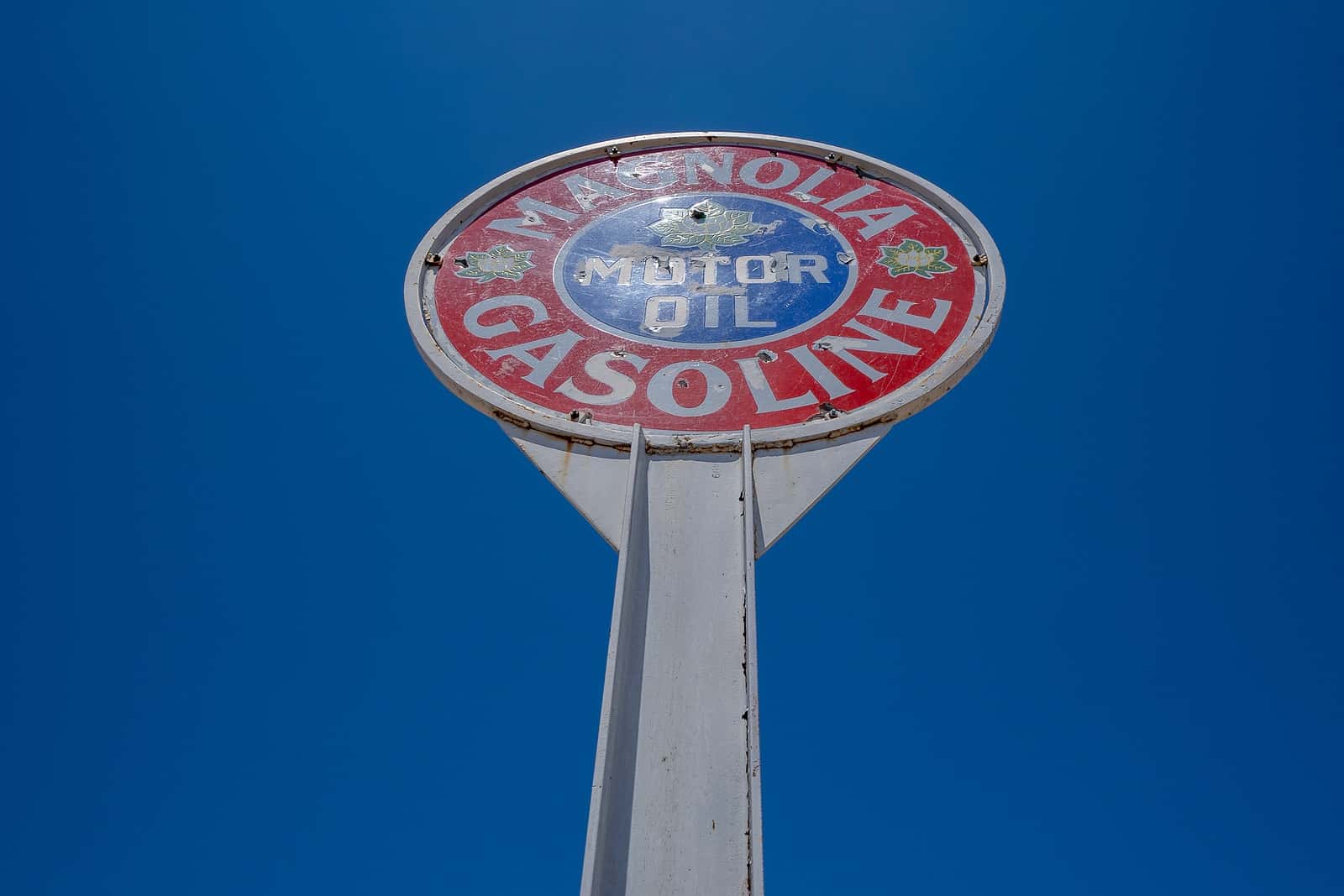 Sign for leaded gasoline designates chemical roots of chronic disease